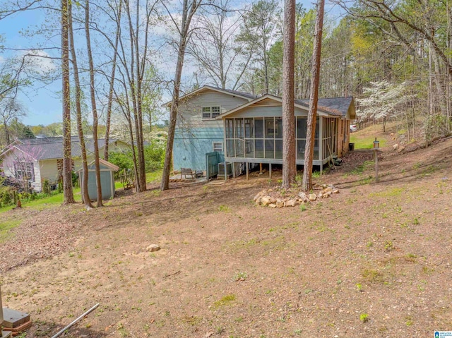 910 12th Ave NE, Jacksonville, AL 36265 - exterior space featuring an outbuilding, a sunroom, and a storage unit