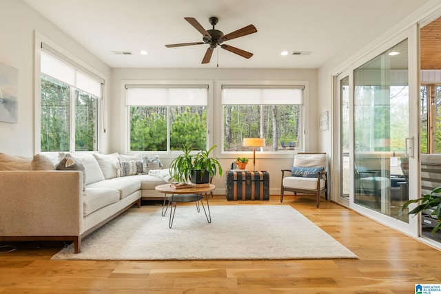sunroom featuring visible vents and plenty of natural light