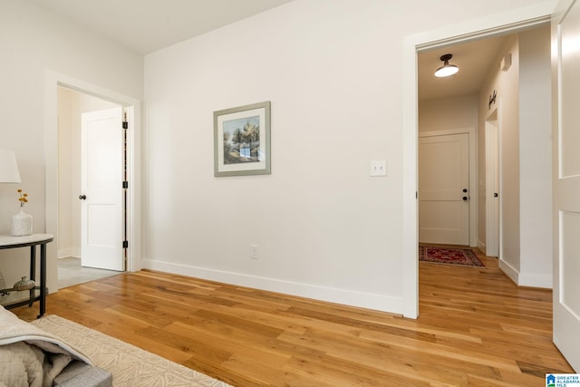 interior space with baseboards and light wood-type flooring