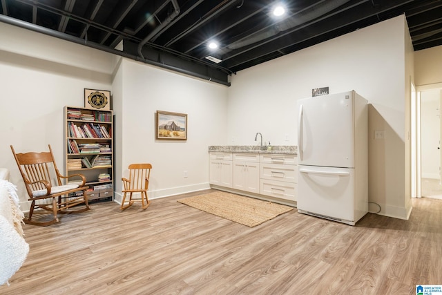 interior space featuring baseboards and light wood-type flooring