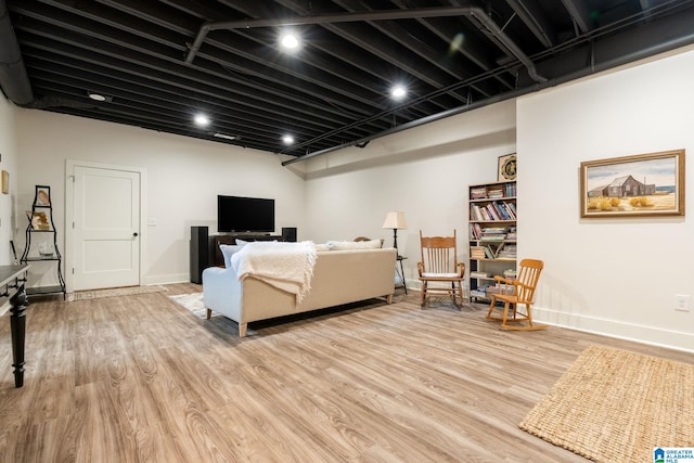 living area featuring light wood-type flooring and baseboards