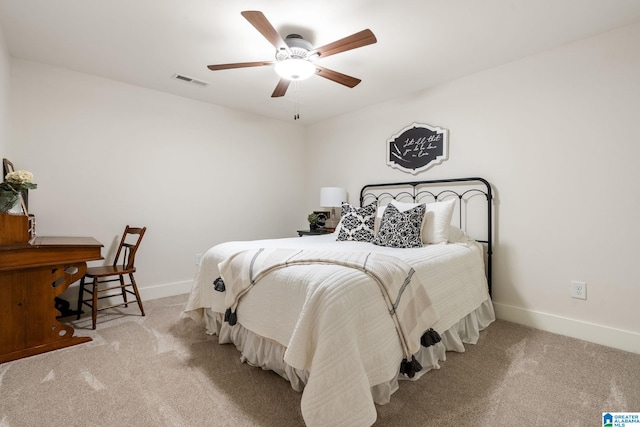 carpeted bedroom with baseboards, a ceiling fan, and visible vents