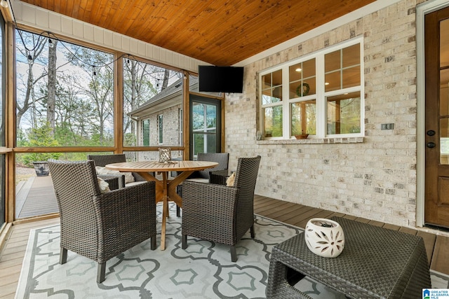 sunroom / solarium featuring outdoor dining space