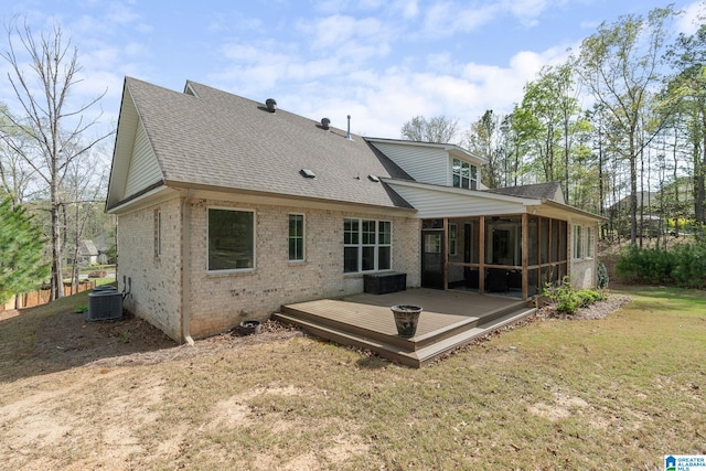 back of house with brick siding, cooling unit, a sunroom, and a shingled roof