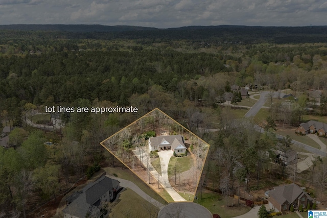 drone / aerial view featuring a forest view