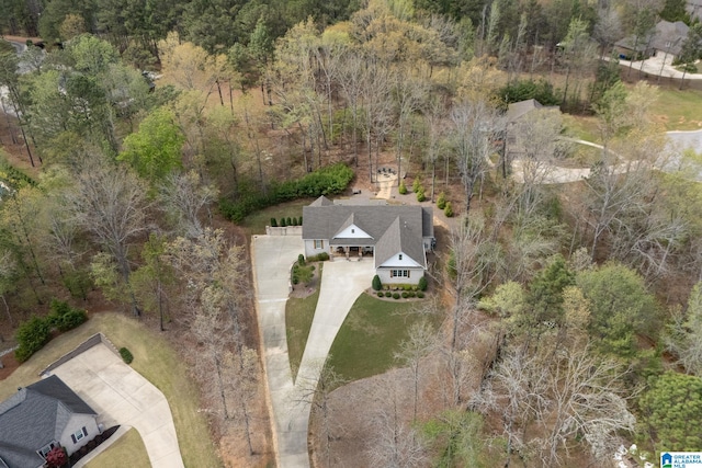 birds eye view of property featuring a view of trees