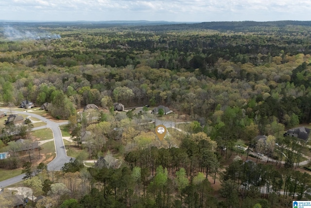 birds eye view of property with a forest view