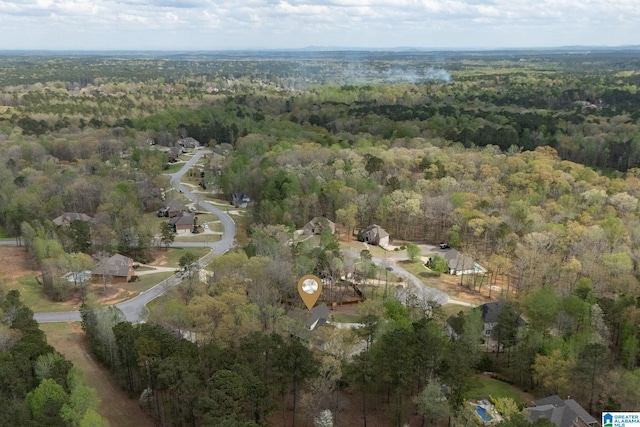 bird's eye view featuring a wooded view