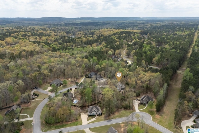 aerial view featuring a wooded view