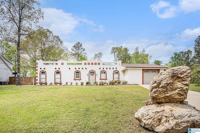 16 Eagle Rock Dr, Alabaster, AL 35007 - mediterranean / spanish house featuring concrete driveway, stucco siding, a front yard, a garage, and fence