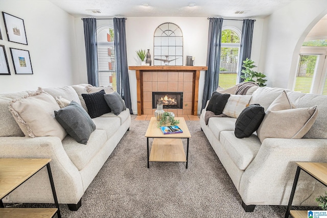 16 Eagle Rock Dr, Alabaster, AL 35007 - living room with arched walkways, a tile fireplace, and visible vents