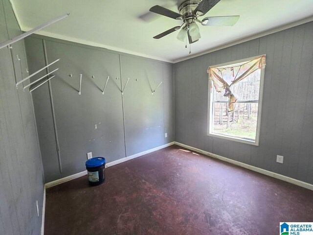 unfurnished bedroom featuring baseboards, concrete flooring, and ceiling fan