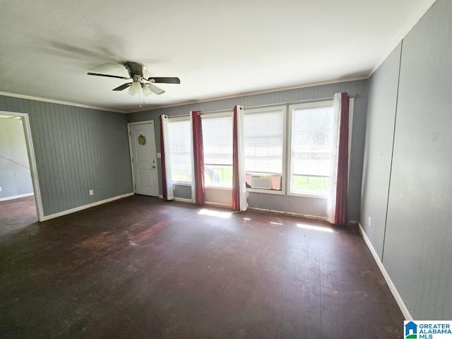 empty room featuring baseboards, crown molding, and ceiling fan