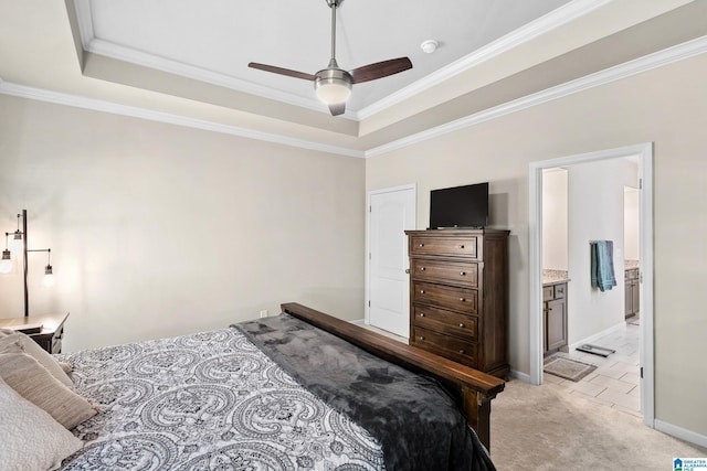 bedroom featuring baseboards, light carpet, crown molding, connected bathroom, and a tray ceiling