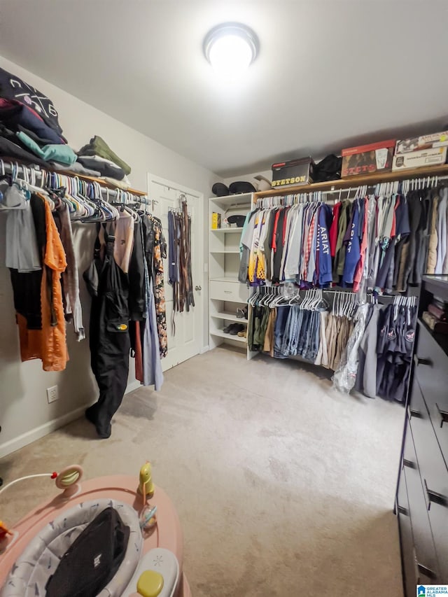 spacious closet with carpet flooring