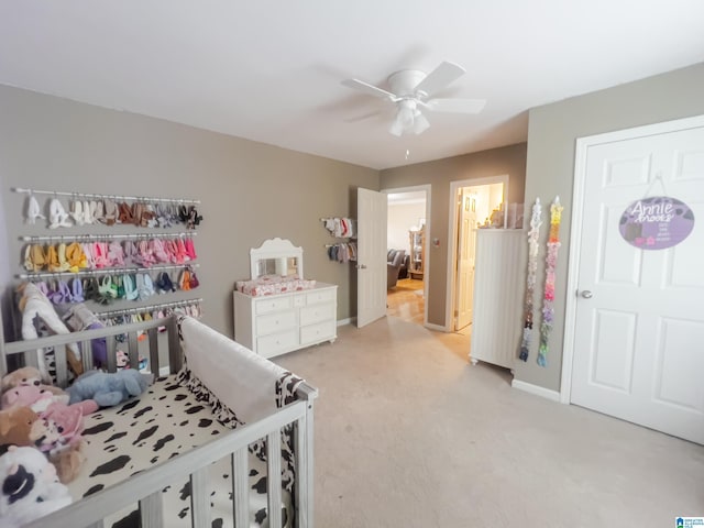 bedroom featuring baseboards, a ceiling fan, and light colored carpet
