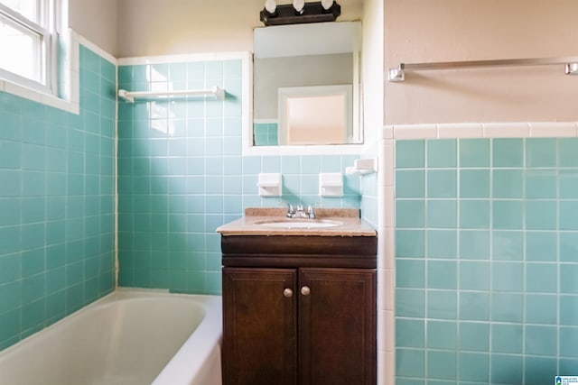 bathroom with vanity,  shower combination, and tile walls
