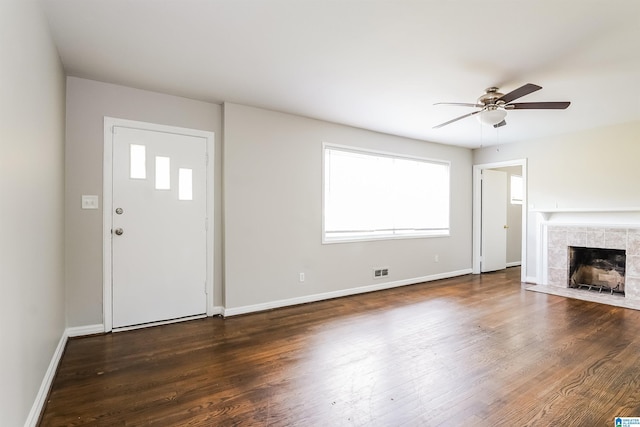 unfurnished living room with ceiling fan, wood finished floors, and baseboards