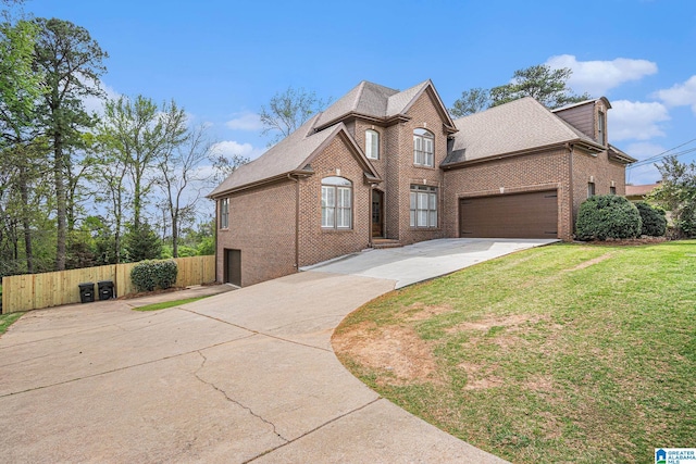 2208 Jacobs Rd, Vestavia Hills, AL 35216 - traditional-style home featuring a front yard, a shingled roof, fence, concrete driveway, and brick siding