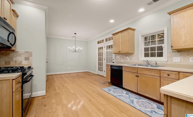 kitchen with light wood-type flooring, light brown cabinetry, visible vents, black appliances, and a sink