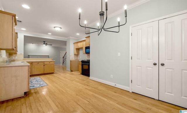 kitchen with tasteful backsplash, ornamental molding, ceiling fan, light wood-type flooring, and black appliances