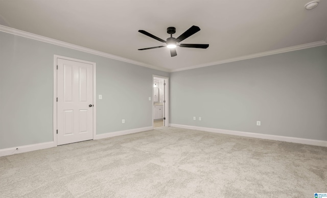 empty room with baseboards, light colored carpet, crown molding, and ceiling fan
