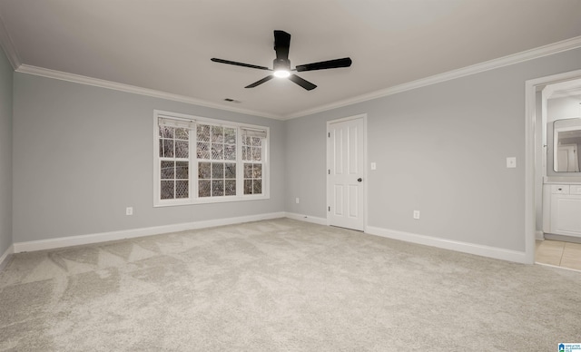 empty room featuring light carpet, baseboards, ornamental molding, and ceiling fan