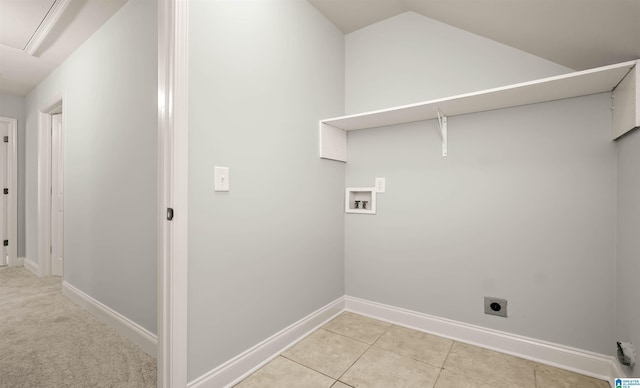 clothes washing area featuring hookup for an electric dryer, baseboards, washer hookup, light tile patterned flooring, and laundry area