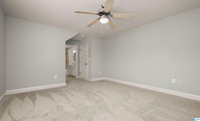unfurnished bedroom featuring carpet flooring, baseboards, connected bathroom, and ceiling fan