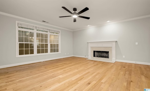 unfurnished living room featuring crown molding, wood finished floors, baseboards, and a ceiling fan