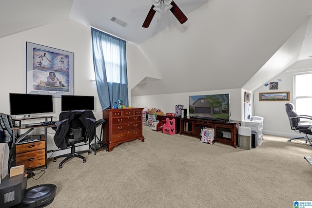 carpeted office with lofted ceiling, visible vents, and ceiling fan