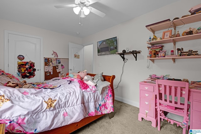 bedroom featuring light colored carpet, baseboards, and a ceiling fan