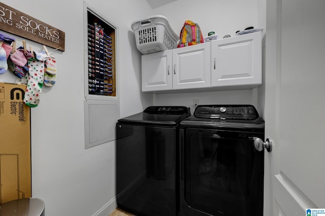 laundry area with washing machine and clothes dryer, cabinet space, and baseboards