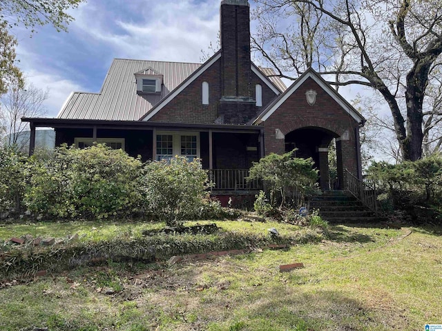 2701 21st St, Birmingham, AL 35208 - view of front of home with brick siding, covered porch, and a chimney