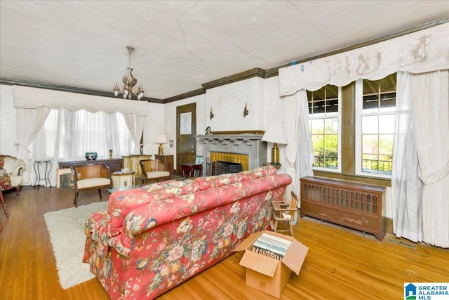 2701 21st St, Birmingham, AL 35208 - living area with a tile fireplace, wood finished floors, and a healthy amount of sunlight