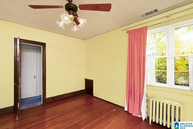 2701 21st St, Birmingham, AL 35208 - spare room with dark wood-style flooring, visible vents, baseboards, and radiator
