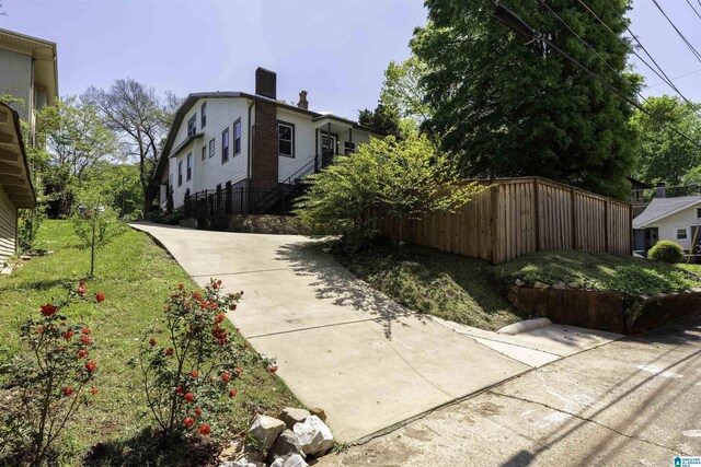 1730 Cullom St S, Birmingham, AL 35205 - view of home's exterior with a yard, fence, and a chimney