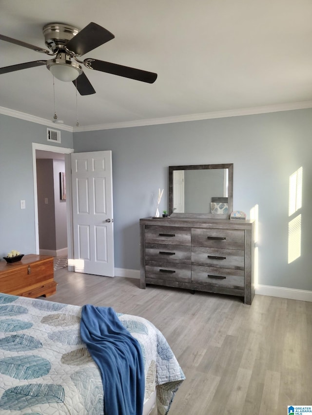 627 Sidney Cir, Anniston, AL 36207 - bedroom with baseboards, ornamental molding, wood finished floors, and visible vents