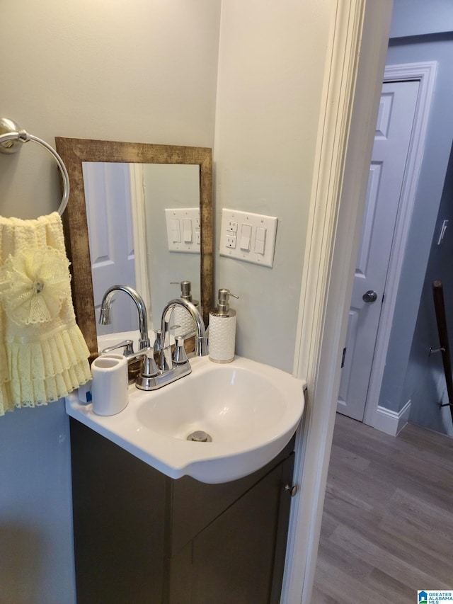 627 Sidney Cir, Anniston, AL 36207 - bathroom with wood finished floors and vanity