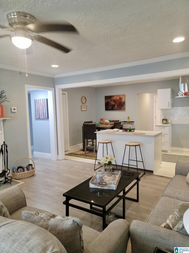 627 Sidney Cir, Anniston, AL 36207 - living area with light wood finished floors, a textured ceiling, crown molding, and ceiling fan