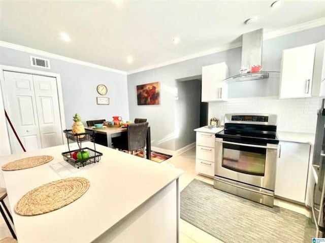 627 Sidney Cir, Anniston, AL 36207 - kitchen featuring wall chimney range hood, stainless steel range with electric stovetop, ornamental molding, and visible vents