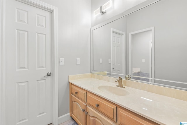 bathroom with vanity and baseboards