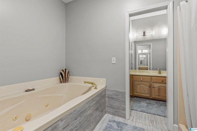 bathroom with vanity and a tub with jets