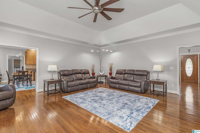 living room with ceiling fan, baseboards, ornamental molding, and hardwood / wood-style flooring