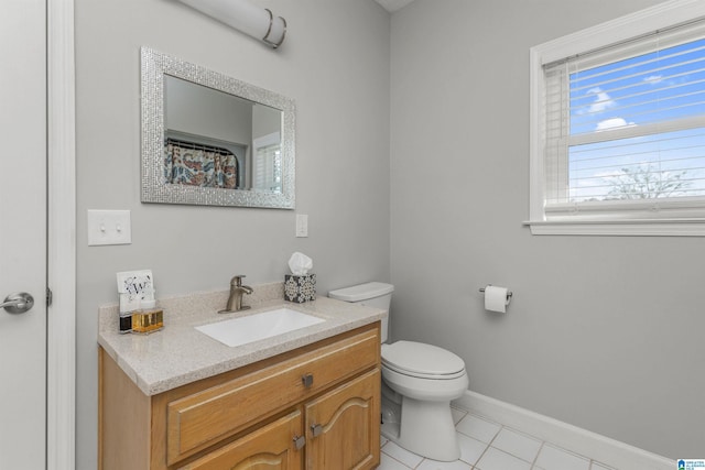 full bathroom with tile patterned floors, vanity, baseboards, and toilet