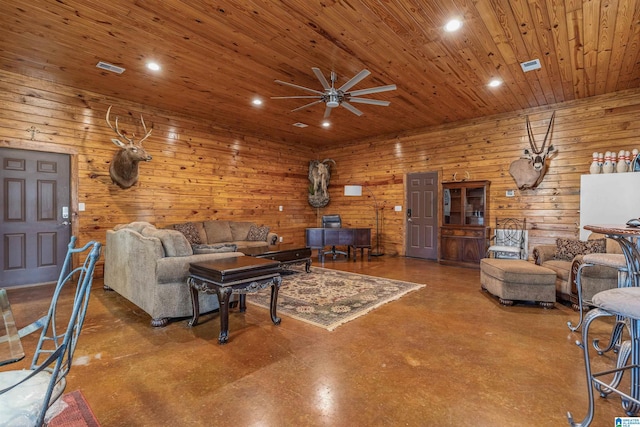living area featuring recessed lighting, a ceiling fan, wood walls, wood ceiling, and concrete flooring