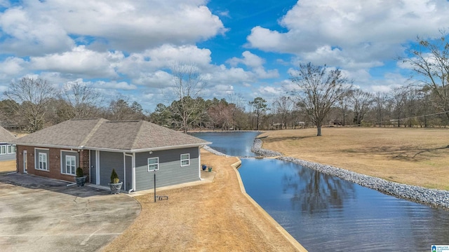 exterior space featuring a water view and a yard