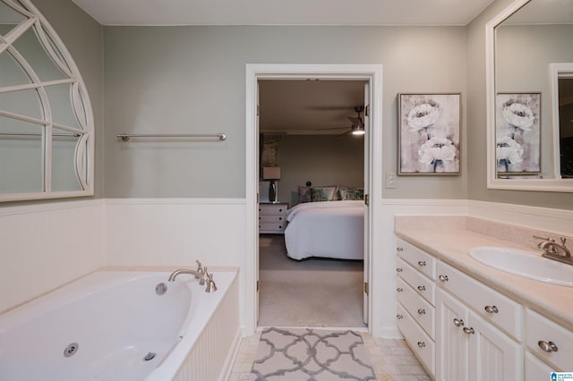 ensuite bathroom featuring a ceiling fan, connected bathroom, vanity, and a garden tub