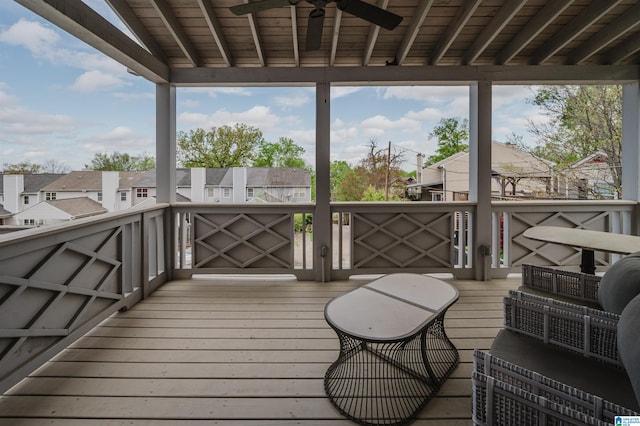 wooden terrace featuring a residential view and a ceiling fan