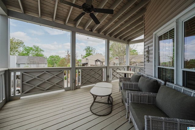 wooden deck with outdoor lounge area and a ceiling fan